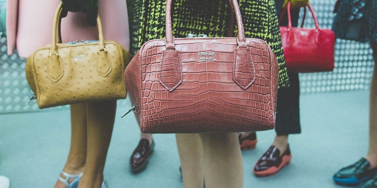 Prada ugly chic heritage, Prada Milano top handle bags in pink and ochre exotic leather carried backstage
