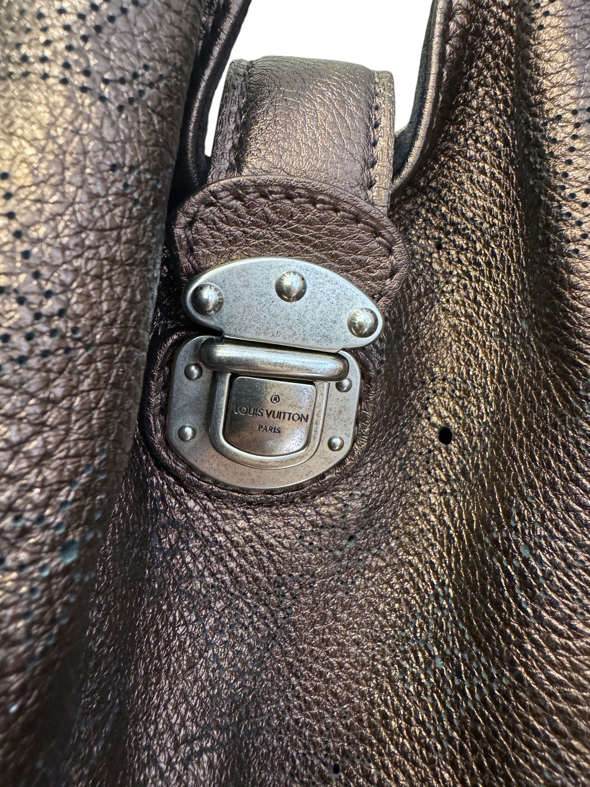 Brandsamsara Louis Vuitton Mahina XL bag featuring brown lasercut monogram leather and silver-tone push-lock hardware