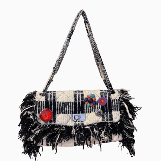 Brandsamsara vintage Chanel flap shoulder bag in multicolor tweed with fringe trim, jeweled brooches, and chain strap.