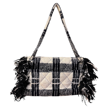 Brandsamsara vintage Chanel flap shoulder bag in black and white plaid tweed with fringe trim and chain strap.
