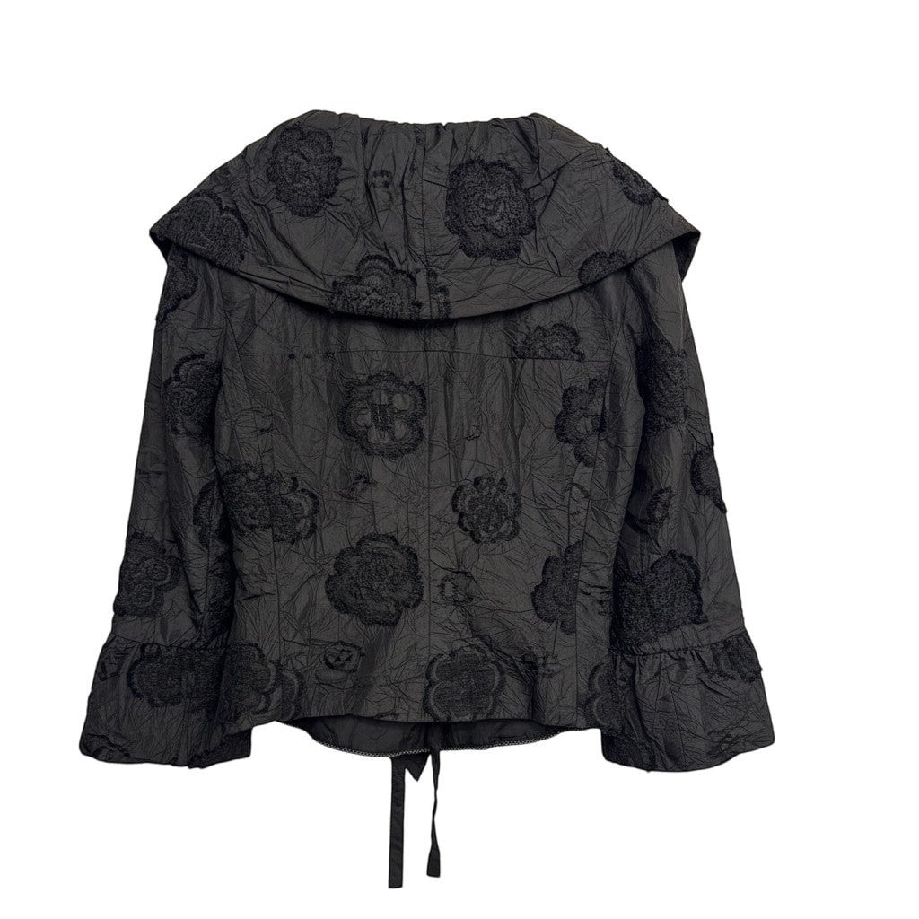 Brandsamsara black textured shirt with floral embroidery and ruffled cuffs, featuring a tie closure at the hem.