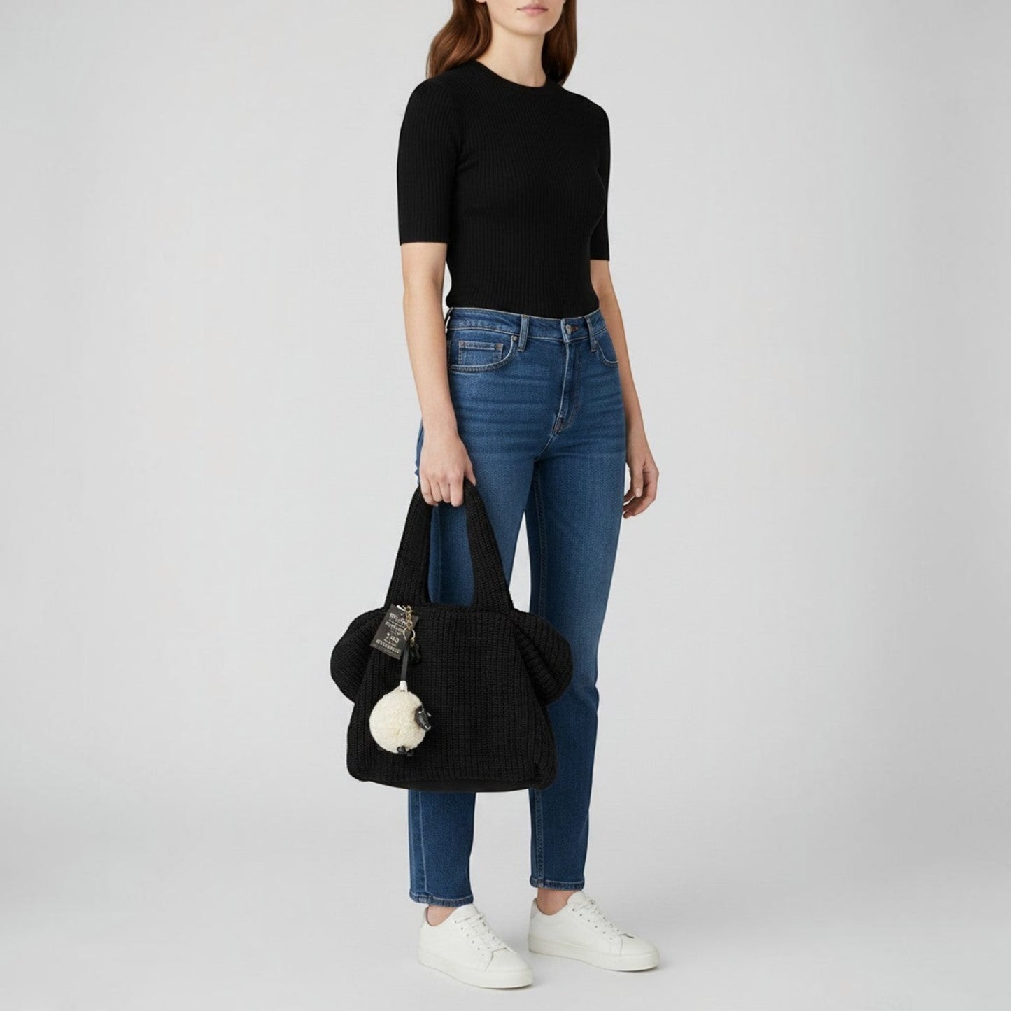 Brandsamsara black knitted shoulder bag with leather details and a sheep charm. Features cotton lining and leather bottom panel.