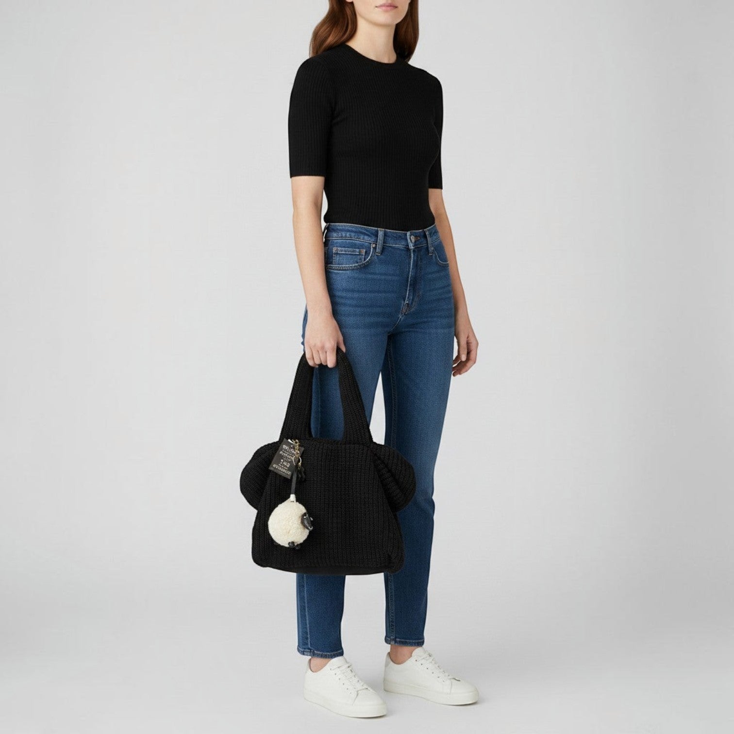 Brandsamsara black knitted shoulder bag with leather details and a sheep charm. Features cotton lining and leather bottom panel.